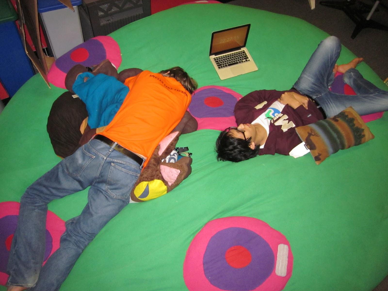 people sleeping on giant pillow