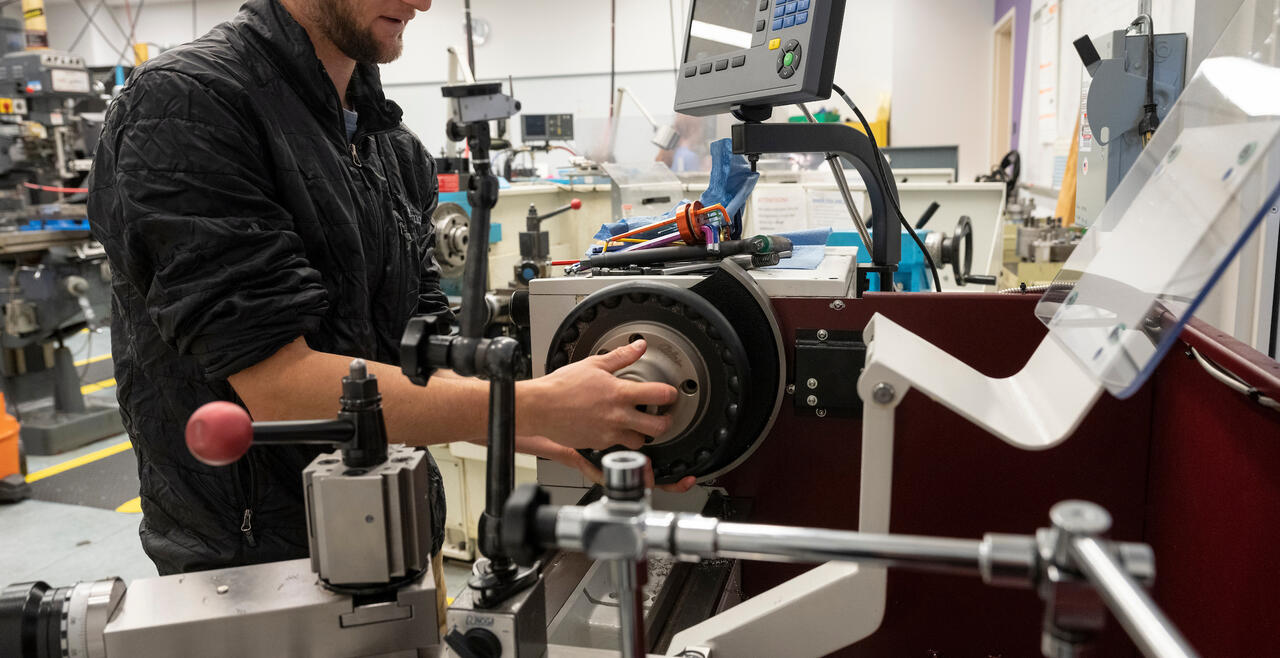 An Olin student using a machine in the Olin Shop during the Fall 2022 semester.