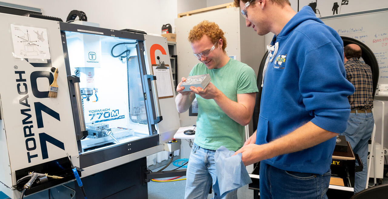 Two students work on machining in the Olin Shop during the Fall 2022 semester.