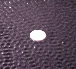 Floater on wavy surface